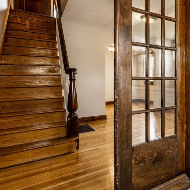 French door entry with stairs leading up to second floor.
